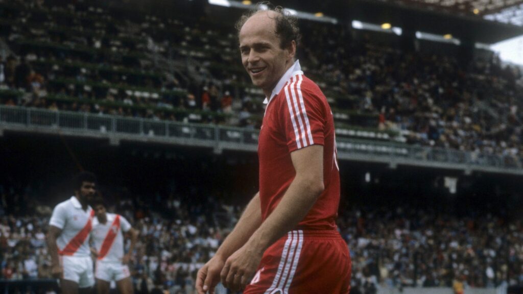 Grzegorz Lato, atacante da Polônia, em ação durante partida da Copa do Mundo de 1982 na Espanha, vestindo o uniforme branco clássico.